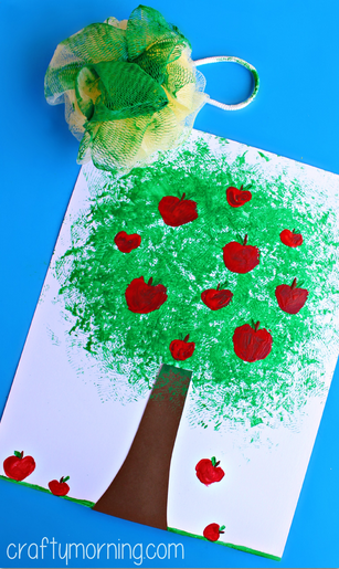 pouf-apple-tree-craft-for-kids with a green sponge leaves, red apples, and brown trunk on white paper